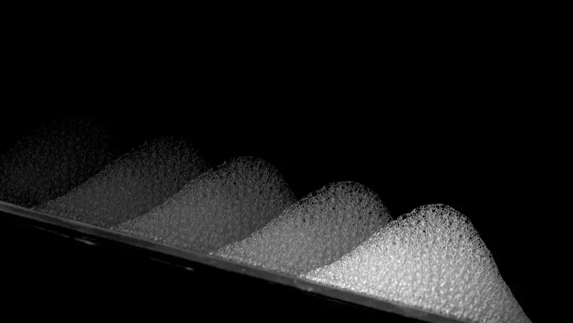 Reducing foam friction with self-slippery liquid-infused porous surfaces